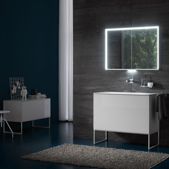 Modernes Badezimmer mit beleuchtetem Spiegelschrank, schlichtem Waschtisch und dunkler Wand. Die Kombination aus dunklen und hellen Elementen verleiht dem Raum Eleganz und Ruhe. Modernes Badezimmer mit beleuchtetem Spiegelschrank, schlichtem Waschtisch und dunkler Wand. Die Kombination aus dunklen und hellen Elementen verleiht dem Raum Eleganz und Ruhe.